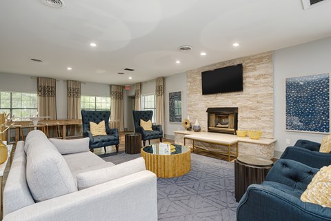 a living room with couches and chairs and a fireplace